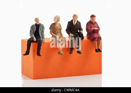 Figurines sitting on block Stock Photo