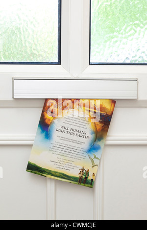 Jehovah Witness brochure The  Watchtower through letterbox in front door Stock Photo