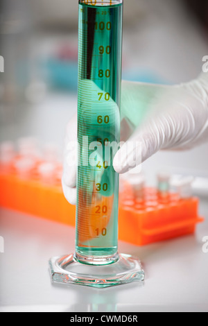 Germany, Bavaria, Munich, Scientist with cylinder doing medical research Stock Photo