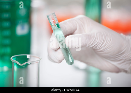 Germany, Bavaria, Munich, Scientist with test tube doing medical research Stock Photo