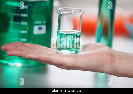 Germany, Bavaria, Munich, Scientist with beaker doing medical research Stock Photo
