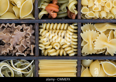 Different types of dried pasta in a wooden tray Stock Photo