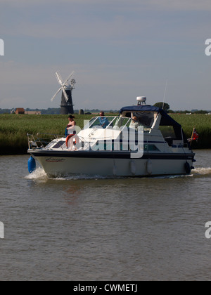 Boat on the Norfolk Broads in front of the Berney Arms Mill, on the bank of the river Yare, UK Stock Photo