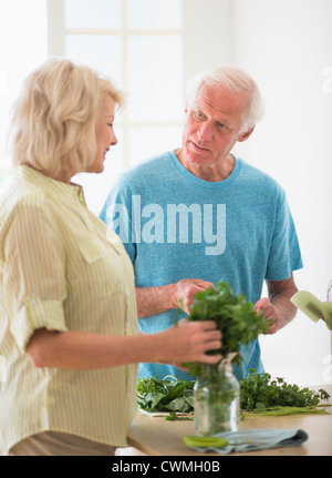 USA, New Jersey, Jersey City, Couple preparing food in kitchen Stock Photo