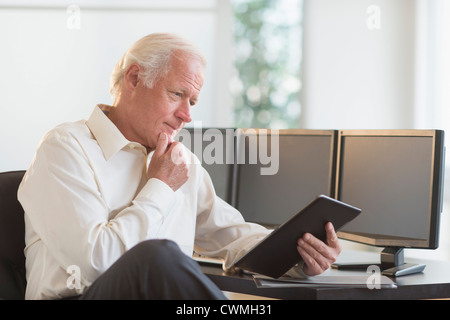 USA, New Jersey, Jersey City, Senior man using tablet pc Stock Photo