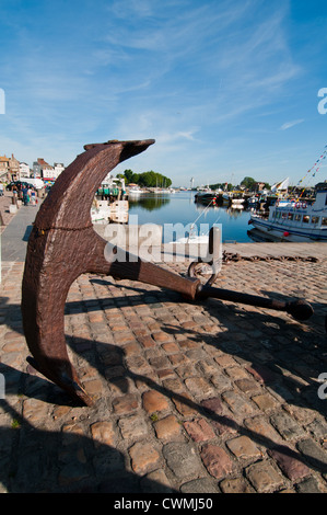 An old anchor at the Honfleur fishing port. The outer harbour is reserved for fishing boats, France. Stock Photo