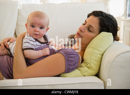 USA, New Jersey, Jersey City, Mother and baby boy (2-5 months) lying together on sofa Stock Photo