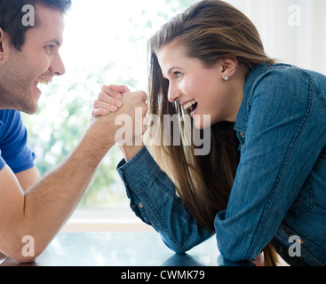 USA, New Jersey, Jersey City, Happy young couple hand wrestling Stock Photo