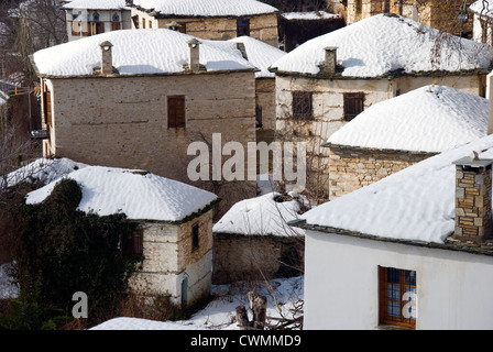 Snowcapped houses in the mountain of village Pinakates in winter (Pelion peninsula, Thessaly, Greece) Stock Photo