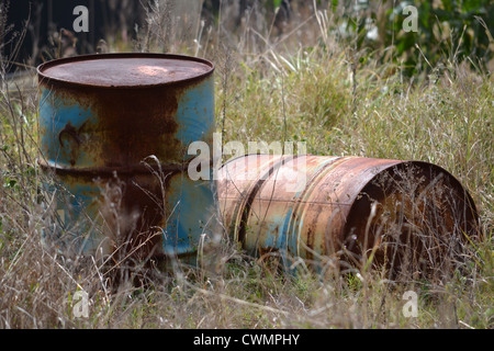 Two old rusty barrels in the bush Stock Photo