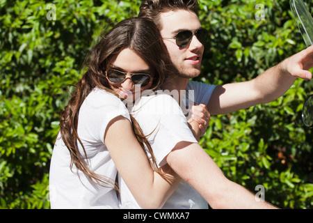 Netherlands, Oisterwijk, Smiling couple on scooter Stock Photo