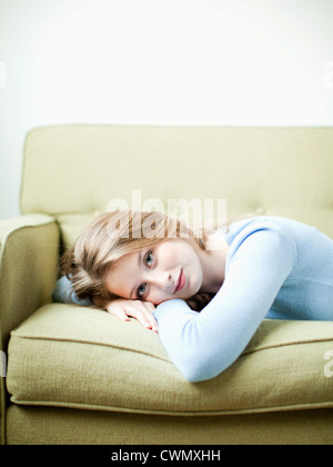 USA, Utah, Salt Lake, Portrait of young woman lying on sofa Stock Photo