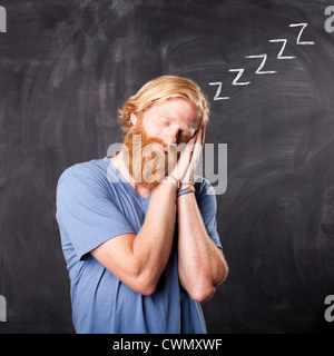USA, Utah, Salt Lake, Man sleeping while standing in front of blackboard Stock Photo