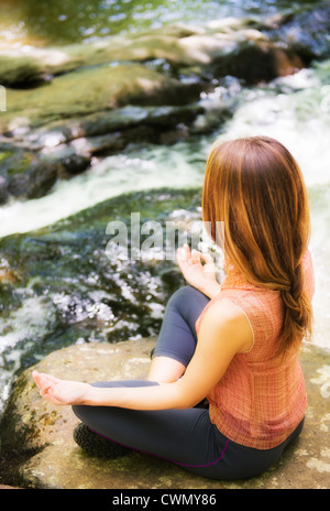 USA, New Jersey, Mendham, Woman practicing joga in forest Stock Photo