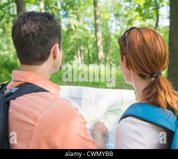 USA, New Jersey, Mendham, Couple hiking with map in forest Stock Photo