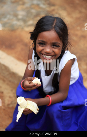 girl eating a banana Andhra Pradesh South India Stock Photo - Alamy