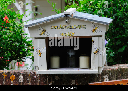 A stall selling local honey in a Dorset village UK Stock Photo