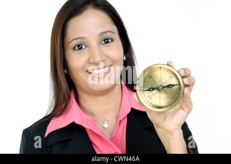 Happy business woman holding a directional compass Stock Photo