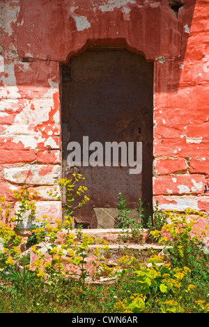 Colorful facade of an old stone house with weathered metal door on Pelion Peninsular, Thessaly, Greece Stock Photo