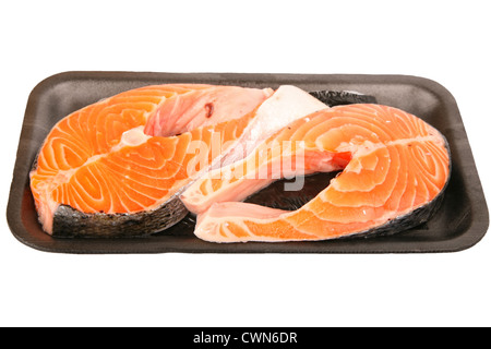 Two fresh Atlantic salmon steaks packed for the supermarket on a foam tray and wrapped in cellophane. Stock Photo