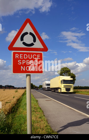 lorry passing reduce speed now warning sign and roundabout ahead uk Stock Photo