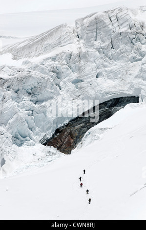 Alpine climbers traveling on a glacier in the Swiss alps Stock Photo