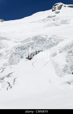 Alpine climbers traveling on a glacier in the Swiss alps Stock Photo