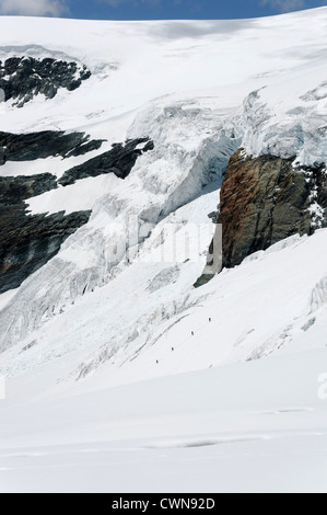 Alpine climbers traveling on a glacier in the Swiss alps Stock Photo