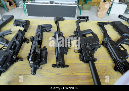 Machine guns and shotguns on a table Stock Photo