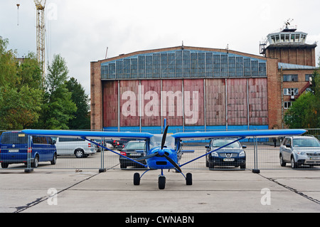 Light airplane for cruising and training on blue colour - front view. Stock Photo