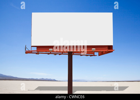 Big, blank billboard in the middle of a mojave desert dry lake. Stock Photo