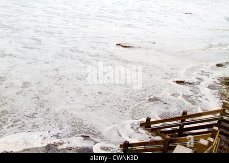 The waves crash on the shore flooding the stairs at high tide on Carmel Beach , California. Stock Photo