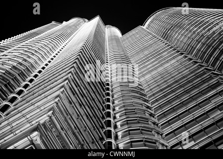Looking up at the incredible skyscrapers of Petronas Towers in Kuala Lumpur. Beautiful architectural design and once tallest building in the world Stock Photo