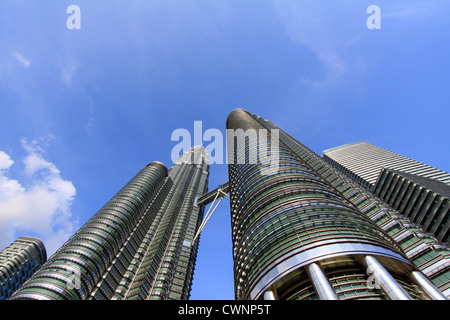 Looking up at towering Petronas Towers. Wide angle cityscape image of two skyscrapers or twin towers in Kuala Lumpur, Malaysia. Low angle view Stock Photo