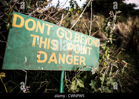 NGORONGORO CONSERVATIONAL AREA, Tanzania - A sign warning of danger at the Simba Campsite on the rim of Ngorongoro Crater in the Ngorongoro Conservation Area, part of Tanzania's northern circuit of national parks and nature preserves. The Ngorongoro Crater, a UNESCO World Heritage Site, is a vast volcanic caldera in northern Tanzania. Created 2-3 million years ago, it measures about 20 kilometers in diameter and is home to diverse wildlife, including the 'Big Five' game animals. The Ngorongoro Conservation Area, inhabited by the Maasai people, also contains significant archaeological sites lik Stock Photo
