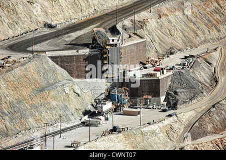 Large mine dump trucks in Kennecott Copper Mine in central Utah. Open pit in background. Worlds largest open pit copper mine. Stock Photo