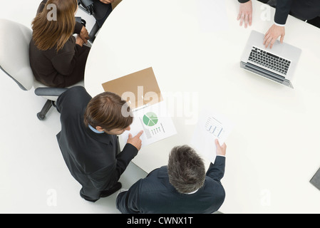 Business associates reviewing documents Stock Photo