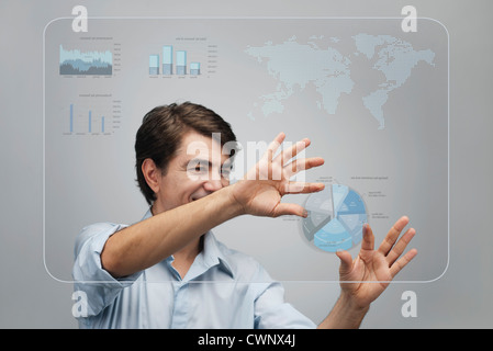 Businessman using advanced touch screen technology to view sales data Stock Photo