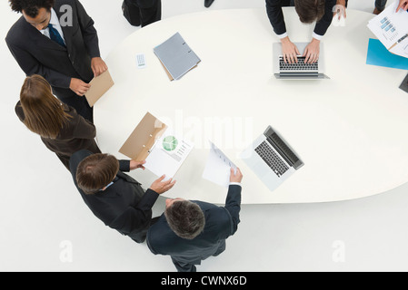 Business associates working together reviewing document Stock Photo