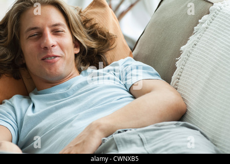 Young man relaxing on sofa Stock Photo