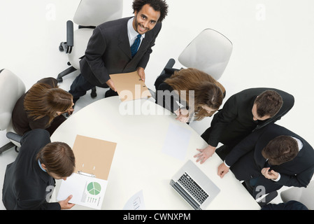 Young businessman giving presentation at meeting Stock Photo