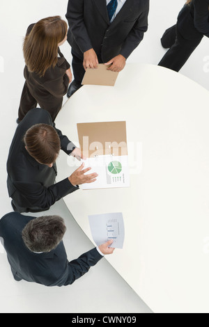 Business associates reviewing documents Stock Photo