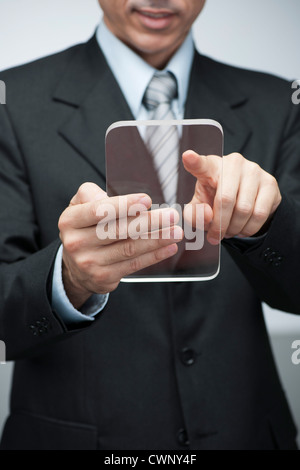 Businessman using transparent digital tablet Stock Photo