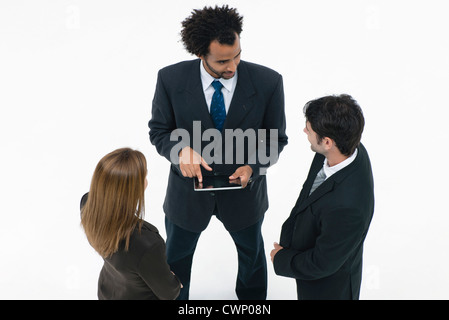 Business associates collaborating with digital tablet Stock Photo