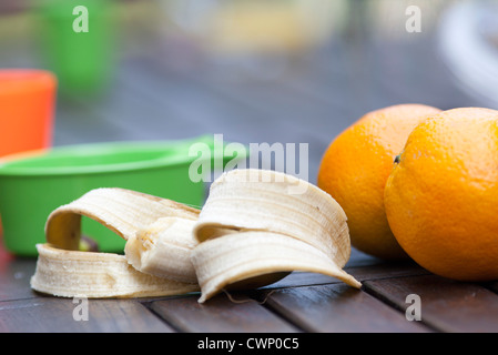 Oranges and half eaten banana Stock Photo