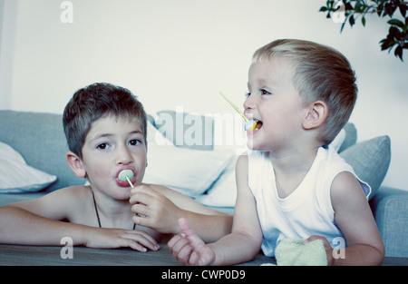 Young boys eating lollipops Stock Photo