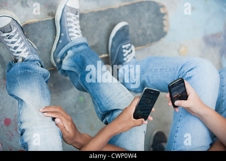 Young men using cell phones, cropped Stock Photo