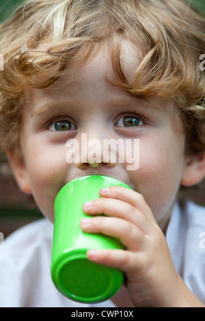 Little boy drinking from cup, portrait Stock Photo