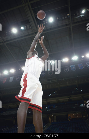 Basketball player shooting basketball Stock Photo