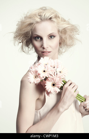Portrait of young woman with bunch of daisies Stock Photo - Alamy